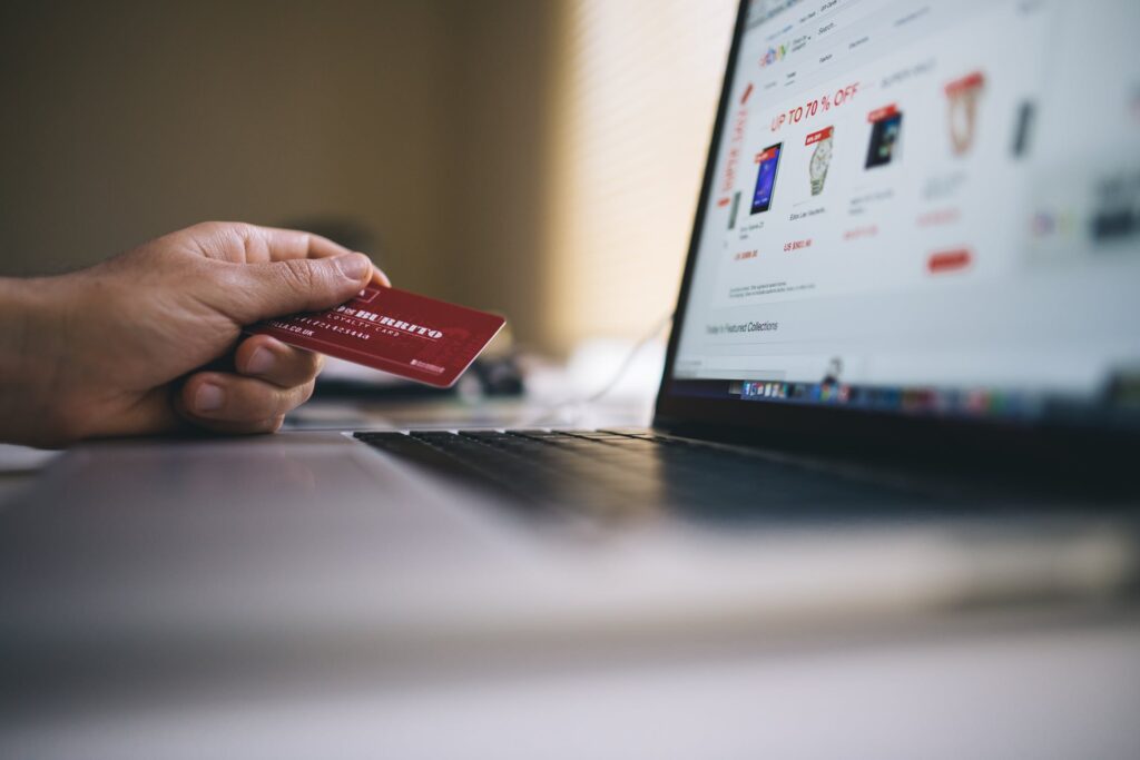 Open Laptop & Hand Holding A Red Smart Card